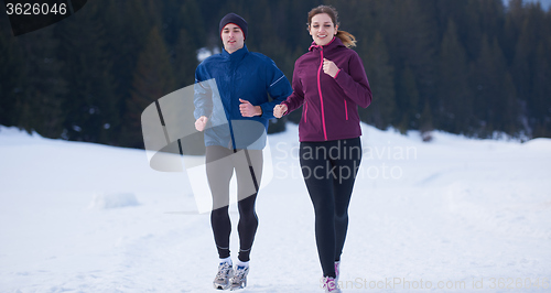 Image of couple jogging outside on snow