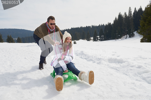 Image of happy young couple having fun on fresh show on winter vacation