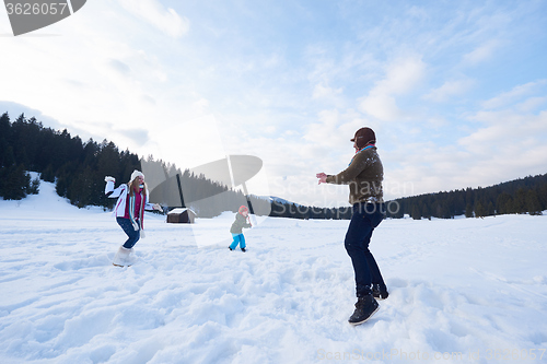 Image of happy family playing together in snow at winter