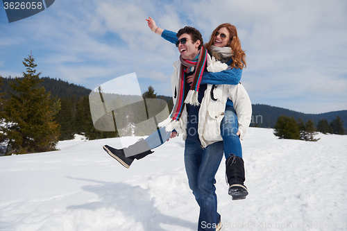 Image of happy young couple having fun on fresh show on winter vacation