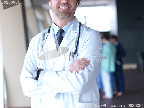 Image of group of medical staff at hospital, doctor in front of team
