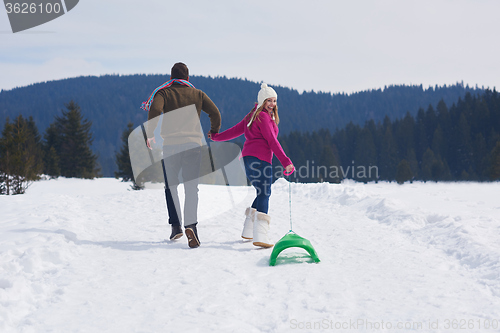 Image of happy young couple having fun on fresh show on winter vacation