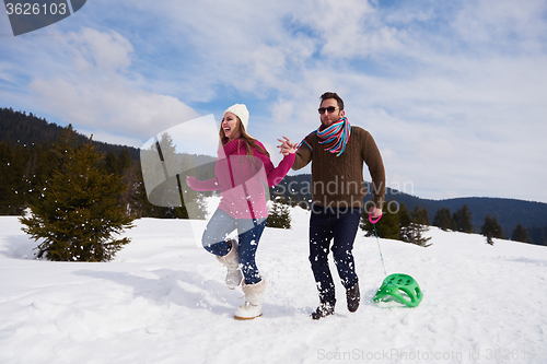 Image of happy young couple having fun on fresh show on winter vacation