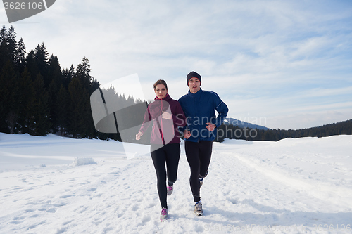 Image of couple jogging outside on snow