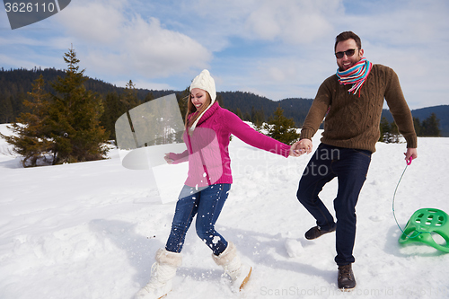 Image of happy young couple having fun on fresh show on winter vacation