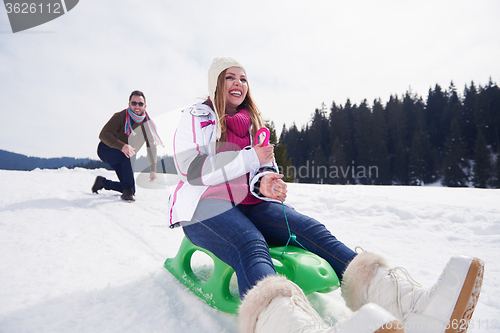 Image of happy young couple having fun on fresh show on winter vacation