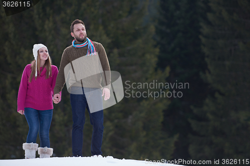 Image of couple having fun and walking in snow shoes