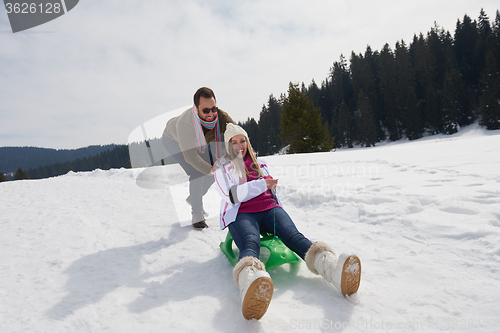 Image of happy young couple having fun on fresh show on winter vacation