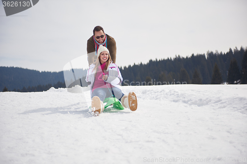 Image of happy young couple having fun on fresh show on winter vacation