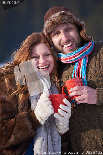 Image of couple drink warm tea at winter