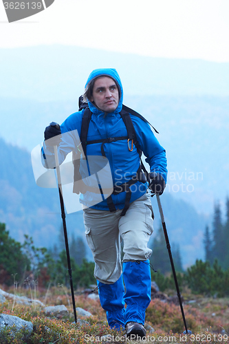 Image of advanture man with backpack hiking