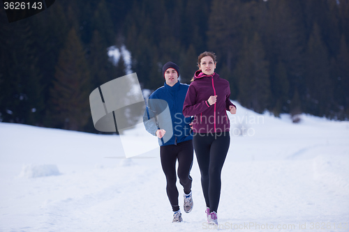 Image of couple jogging outside on snow