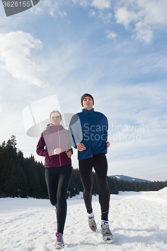 Image of couple jogging outside on snow