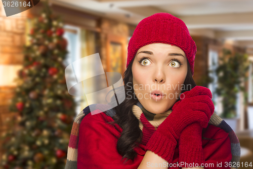 Image of Mixed Race Woman Wearing Mittens and Hat In Christmas Setting