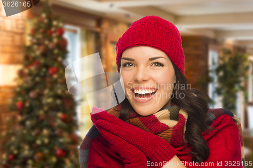 Image of Mixed Race Woman Wearing Mittens and Hat In Christmas Setting