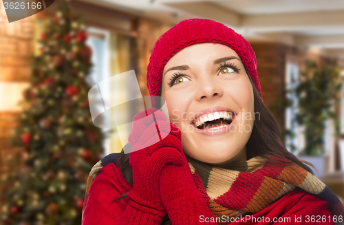 Image of Mixed Race Woman Wearing Mittens and Hat In Christmas Setting