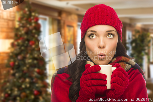 Image of Mixed Race Woman Wearing Hat and Gloves In Christmas Setting