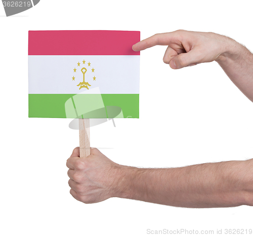 Image of Hand holding small card - Flag of Tajikistan