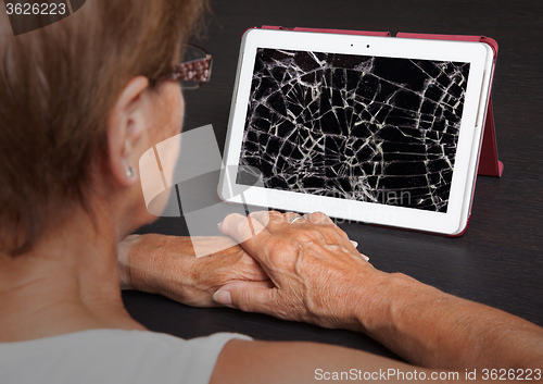 Image of Senior lady with tablet, cracked screen