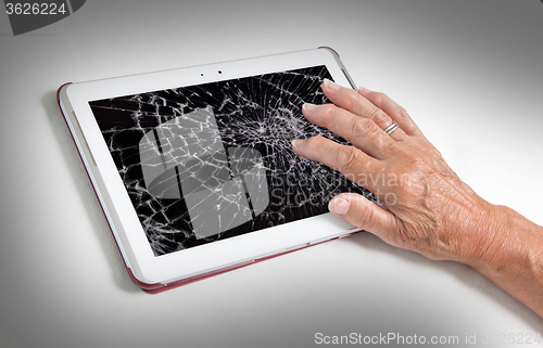 Image of Senior lady with tablet, cracked screen