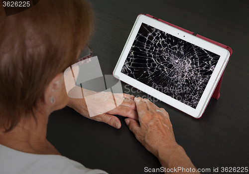 Image of Senior lady with tablet, cracked screen