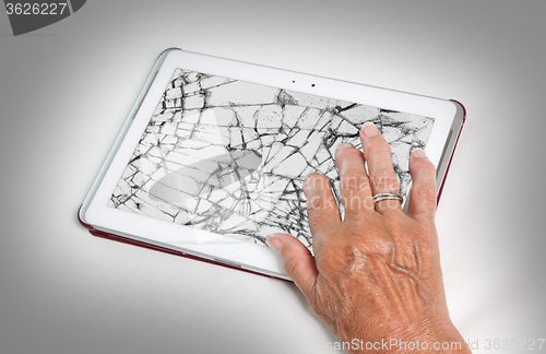 Image of Senior lady with tablet, cracked screen