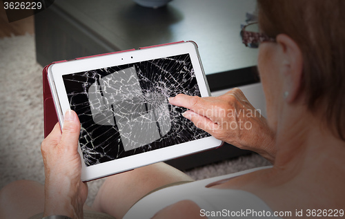 Image of Senior lady with tablet, cracked screen