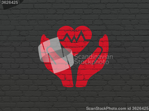 Image of Insurance concept: Heart And Palm on wall background