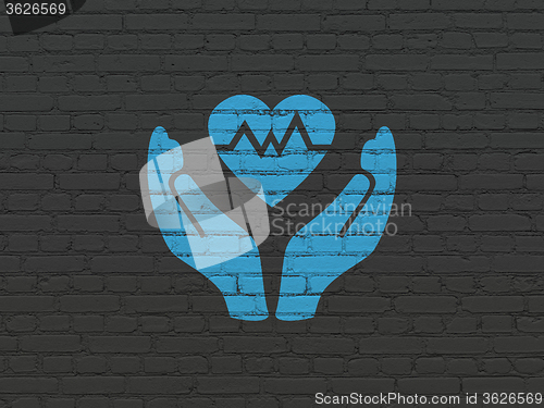 Image of Insurance concept: Heart And Palm on wall background