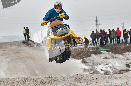 Image of High jump of sportsman on snowmobile