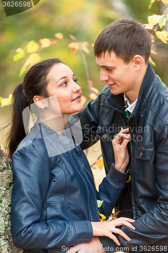 Image of Young romantic happy couple in autumn park