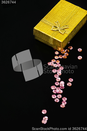 Image of Gold christmas gift box and pink sequins