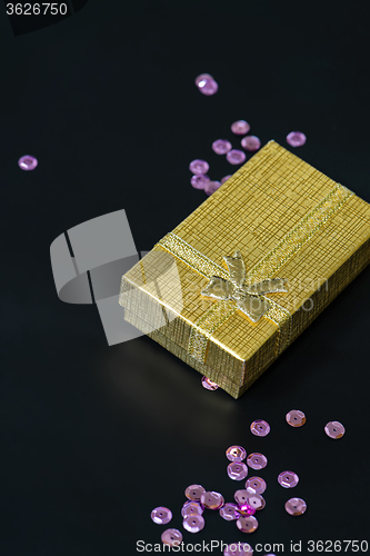 Image of Gold christmas gift box and pink sequins