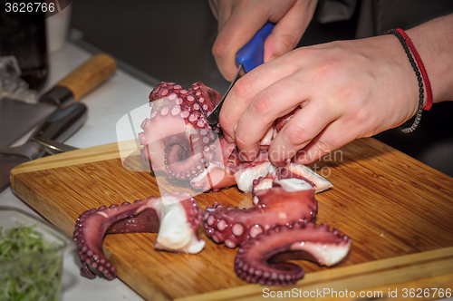 Image of chef cutting octopus 