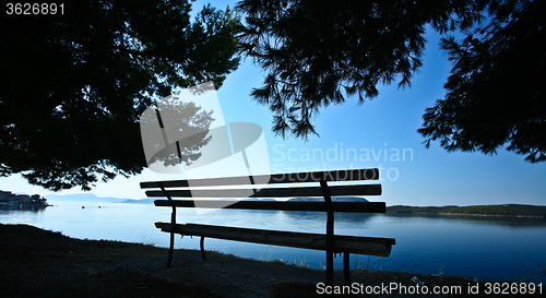 Image of Trees and bench at the coast line in   Peloponese in Greece