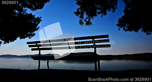 Image of Trees and bench at the coast line in   Peloponese in Greece