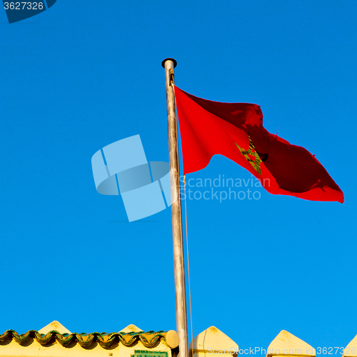 Image of tunisia  waving flag in the blue sky  colour and battlements  wa