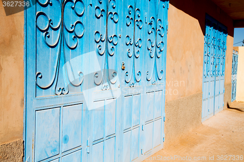 Image of blue morocco old door and historical nail wood