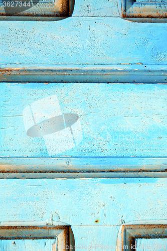 Image of stripped paint in  blue wood door and  