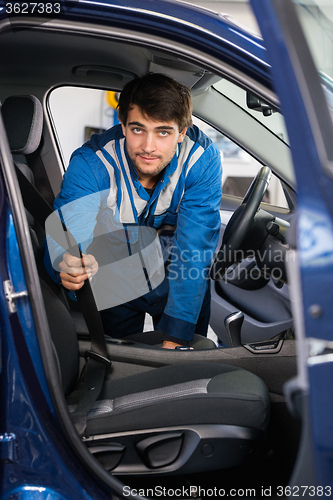 Image of Portrait Of Mechanic Examining Car Seat Belt