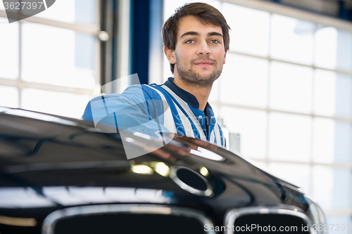 Image of Mechanic Discussing With Female Customer In Garage