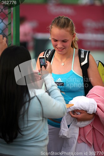 Image of Caroline Wozniacki gives autographs in Doha, Qatar