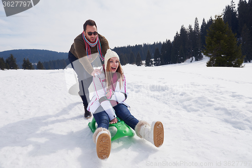 Image of happy young couple having fun on fresh show on winter vacation