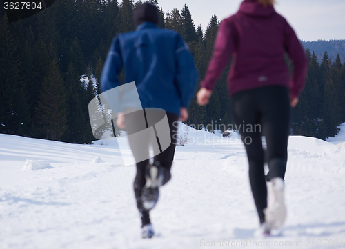 Image of couple jogging outside on snow