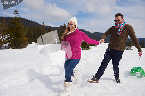 Image of happy young couple having fun on fresh show on winter vacation