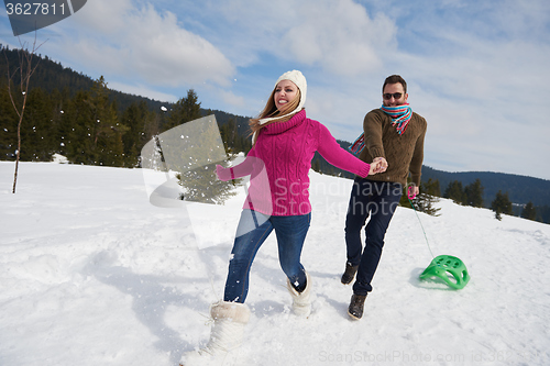 Image of happy young couple having fun on fresh show on winter vacation