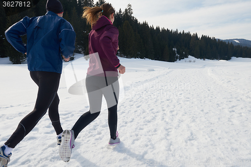 Image of couple jogging outside on snow