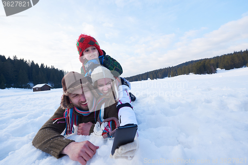 Image of romantic couple have fun in fresh snow and taking selfie