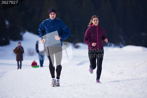 Image of couple jogging outside on snow