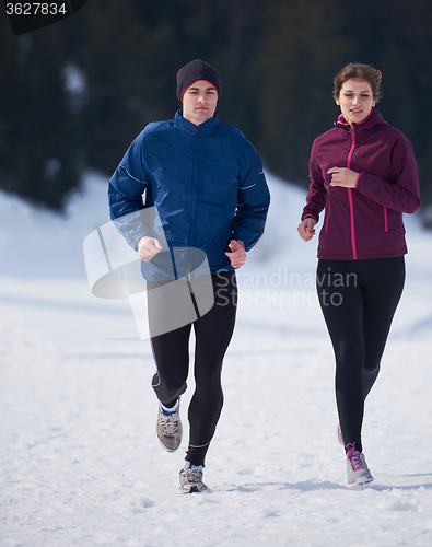 Image of couple jogging outside on snow